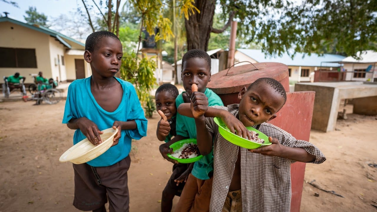 Four Kenyan boys enjoying a snack.