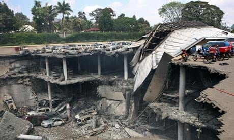An outdoor parking garage which has been absolutely destroyed by a terrorist attack.