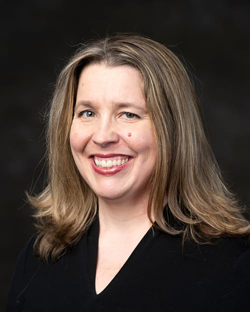 Headshot of an adult woman wearing a black shirt