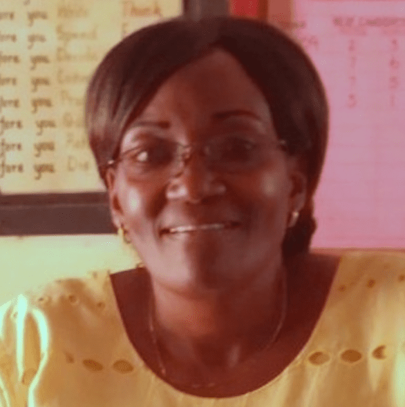 A Kenyan woman wearing a yellow shirt.