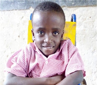 Brighton- smiling young boy wearing a red and white gingham shirt.