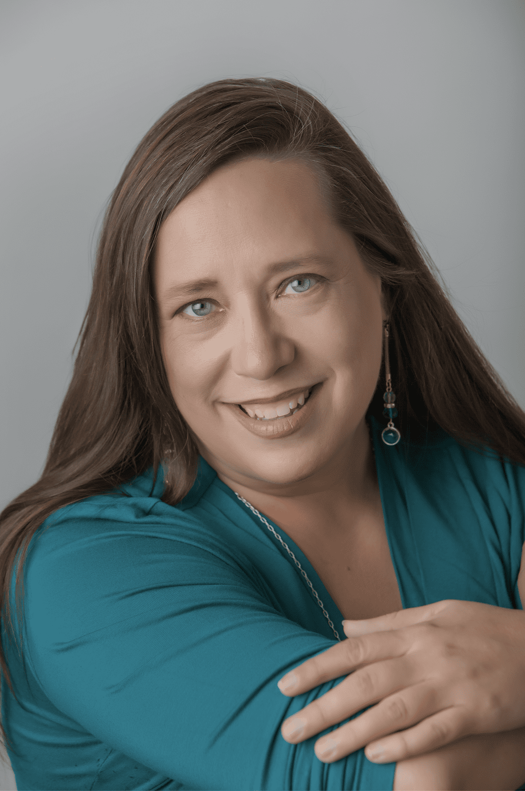 Headshot of a woman, Michele Reber, wearing a blue shirt