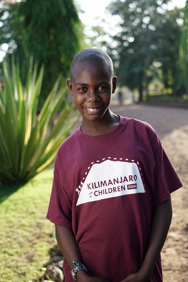 Girl smiling wearing maroon shirt outside