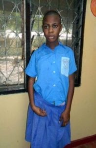 Girl standing inside wearing blue shirt