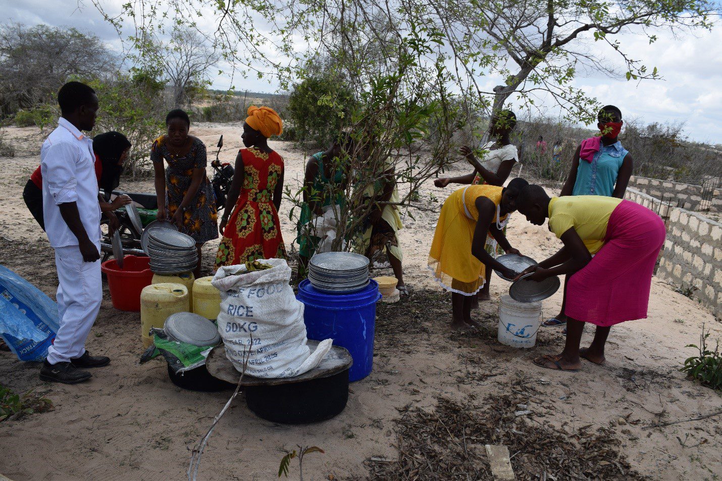 Community members receiving rice