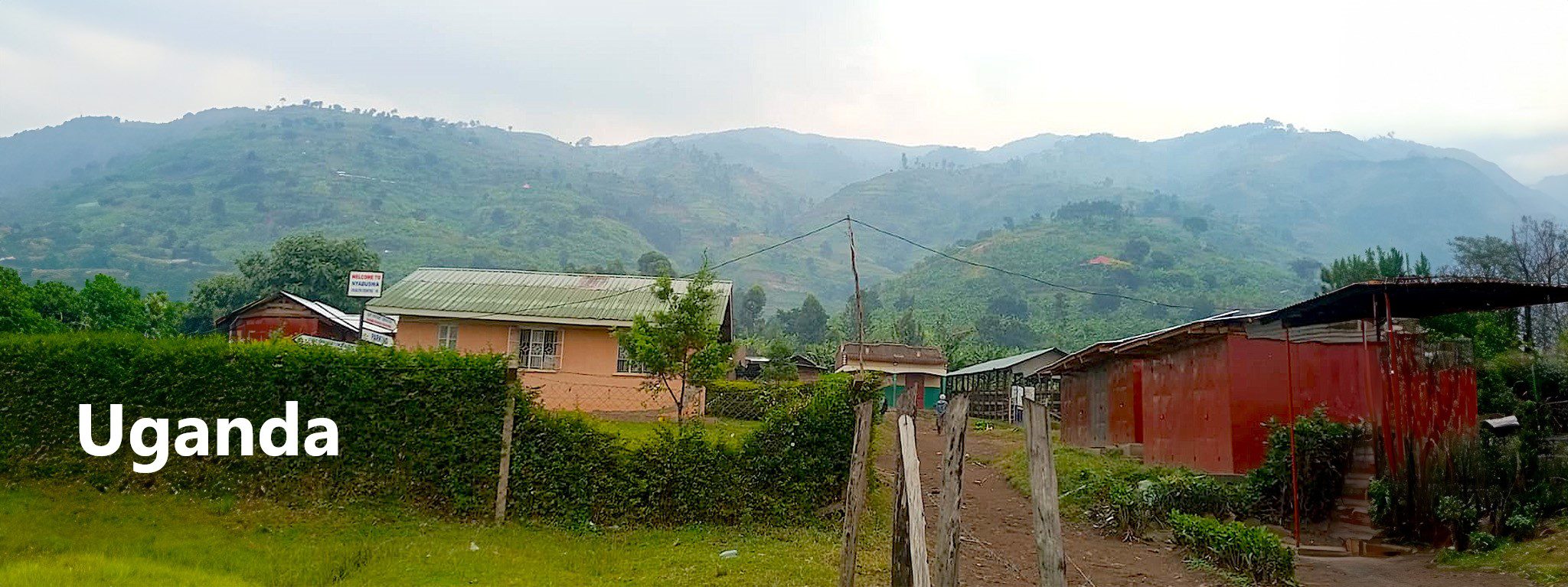 A green mountainous landscape with a cloudy sky.