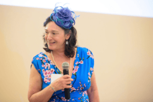 woman in blue dress and fancy blue hat