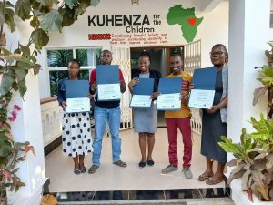 Kuhenza staff standing in a row with certificates